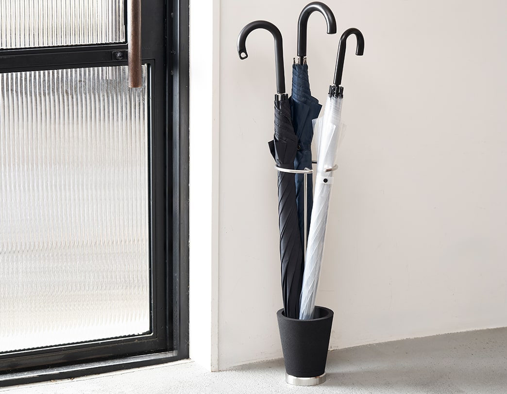 Sustainable umbrella stand made of stainless steel and recycled resin